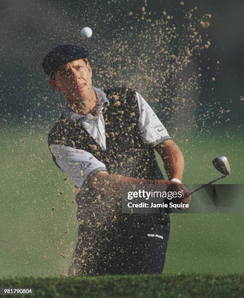 Payne Stewart of the United States keeps his eye on the ball as he hits out of the bunker during the Mercedes Championships golf tournament on 6...