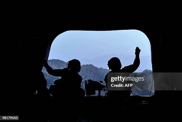 Army soldiers stay alert onboard a military helicopter during a flight from Camp Salerno to Forward Operating Base Sharana in Paktika province on...