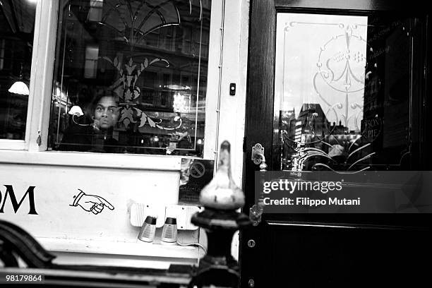 Girl watches out of the window from a pub in Soho, on January 9, 2009 in London, England.