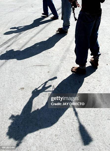 The shadows of devotees are seen in the city of San Fernando, Pampanga in the Roman Catholic Philippines, as people take part in the annual Maundy...