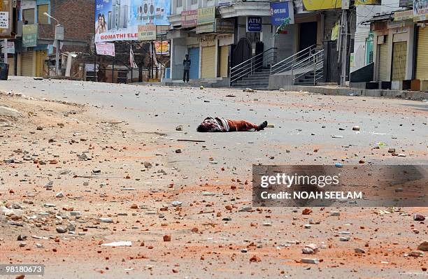 Bloodied Indian man injured by pelting stones lies unconscious at the scene of clashes between two communities in the Sha Ali Banda area of the old...