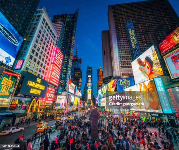 times square in new york city at dusk - broadway manhattan stock pictures, royalty-free photos & images