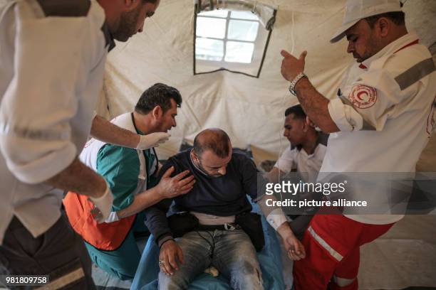 Dpatop - Palestinian photojournalist, Mohammed Saber, receives treatment at a medical tent during clashes with Israeli Security Forces along the...