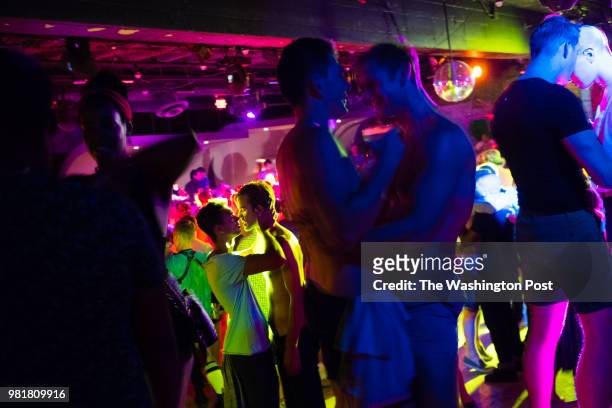 Couples kiss on the dance floor. Town Danceboutique is the largest gay danceclub in Washington, D.C. Northwest Washington, DC is the city's largest...
