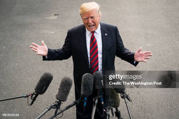 President Donald J. Trump stops to speak to reporters and members of the media as he departs for the G7 Summit in Canada, from the South Lawn of the...