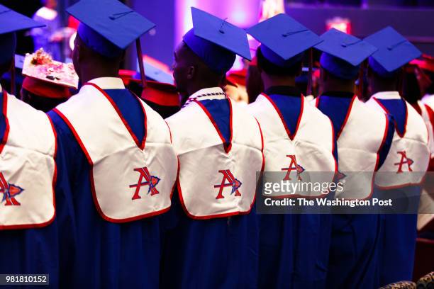 Students from Anacostia High School stand up as their graduation ceremony begins.