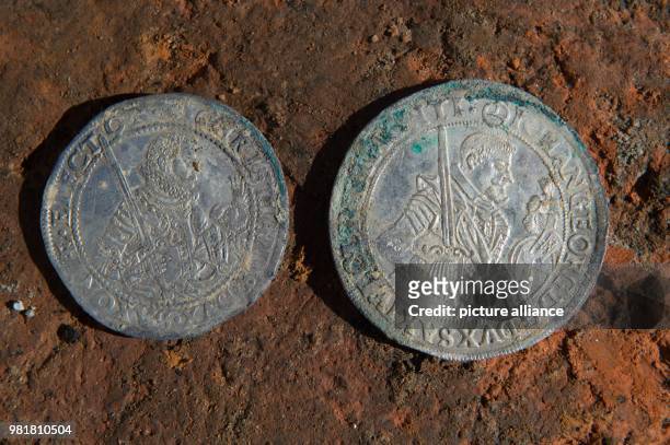 April 2018, Germany, Bautzen: Two silver coins with the imprints of electoral prince Christian and Johann Georg of Saxony in the excavation site of...