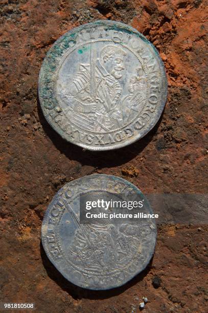 April 2018, Germany, Bautzen: Two silver coins with the imprints of electoral prince Christian and Johann Georg of Saxony in the excavation site of...