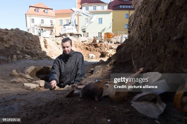April 2018, Germany, Bautzen: Nicole Eichhorn, lead archaeologist of the State Office, works on a well of the excavation area in the old town....