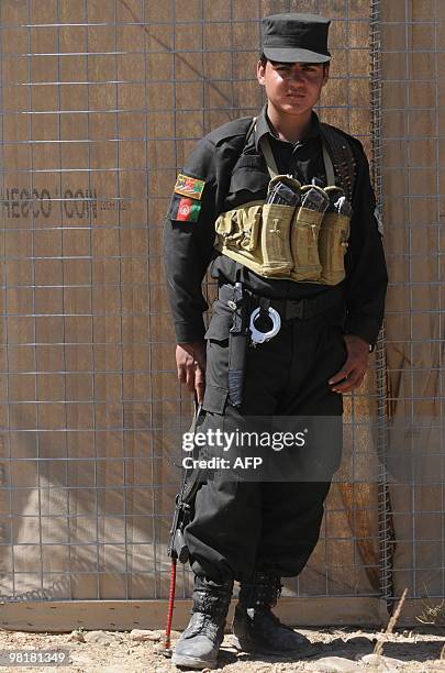 An Afghan policeman looks on during a patrol in Sar Hawza district of Paktika province on March 31, 2010. A bomb attack in a crowded market in...