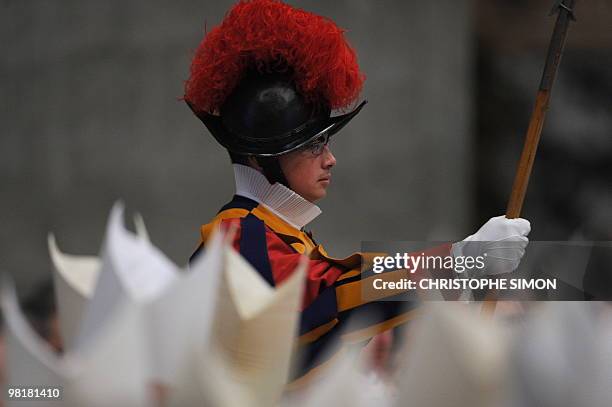 Swiss guard stands as eccliesiastics attend Pope Benedict XVI's Holy Thursday Chrism mass as part of the Holy week on April 01, 2010 at St Peter's...