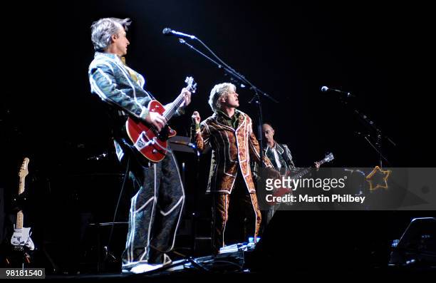 Neil Finn, Tim Finn and Nigel Griggs of Split Enz perform on stage at the Rod Laver Arena on 12th June 2006 in Melbourne, Australia.