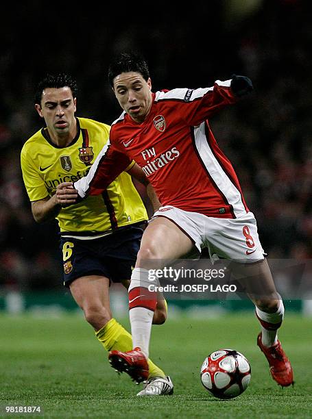 Arsenal's French midfielder Samir Nasri vies with Barcelona's Spanish midfielder Xavi Hernandez during their UEFA Champions League quarter-final 1st...