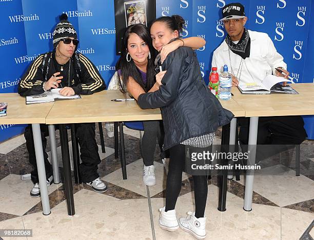 Dino "Dappy" Contostavlos, Tula "Tulisa" Contostavlos and Richard "Fazer" Rawson of N-Dubz pose with a young fan at a photocall for the launch of the...