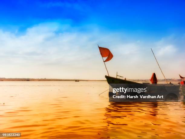 boat with flag in ganga river at banaras india - ganga stock pictures, royalty-free photos & images