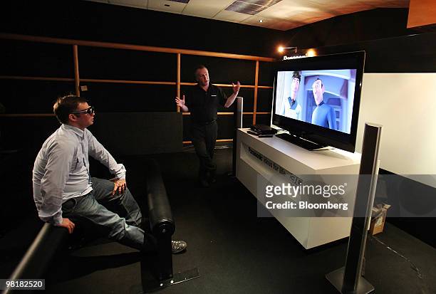 Journalist, left, is shown the latest 3-D TV and Blu-ray disc player by a Panasonic Corp. Employee at the headquarters of Panasonic U.K. In London,...