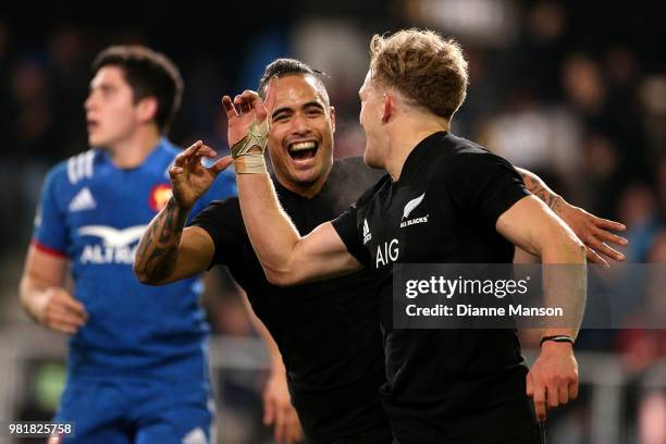 Damian McKenzie of the All Blacks celebrates his try with team-mate Aaron Smith during the International Test match between the New Zealand All...