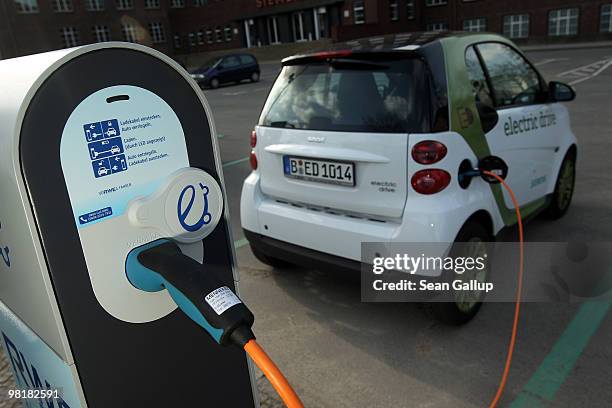 Company electric Smart car of German engineering company Siemens, at the behest of the photographer, stands attached via a charging cable from a...