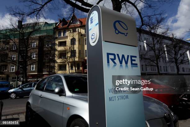 Gasoline-powered cars stand parked next to a sidewalk-mounted electric car charger on April 1, 2010 in Berlin, Germany. German power producer RWE has...