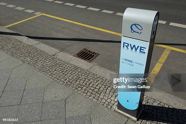 Sidewalk-mounted electric car charger stands next to parking spaces reserved for electric cars in the city center on April 1, 2010 in Berlin,...