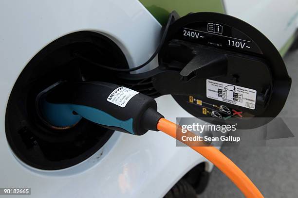 Company electric Smart car of German engineering company Siemens, at the behest of the photographer, stands attached via a charging cable from a...