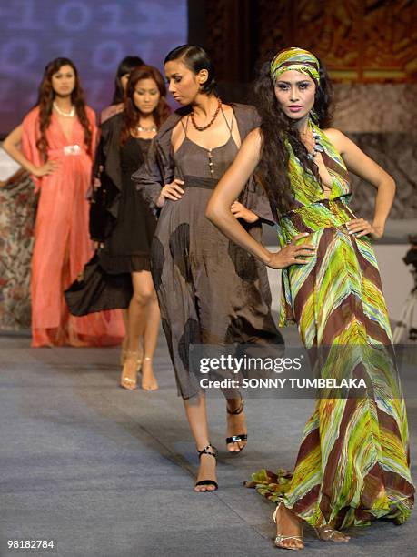 The silhouettes of Indonesian models are seen as they display outfits created by Marilena Vlataki on the second day of Bali Fashion Week 2008 in...