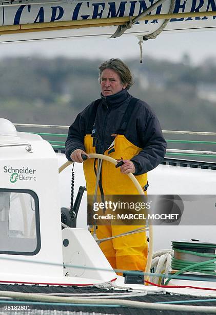 Frenchman Olivier de Kersauson stands at the wheel of his Jeronimo maxi-trimaran in the Moulin Blanc harbour in Brest, Brittanny, 25 February 2004,...