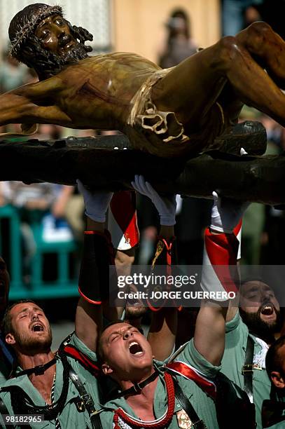 Members of the Spanish Legion carry the icon of Christ of the Good Death to the Santo Domingo de Guzman Church during an Easter procession on 1...