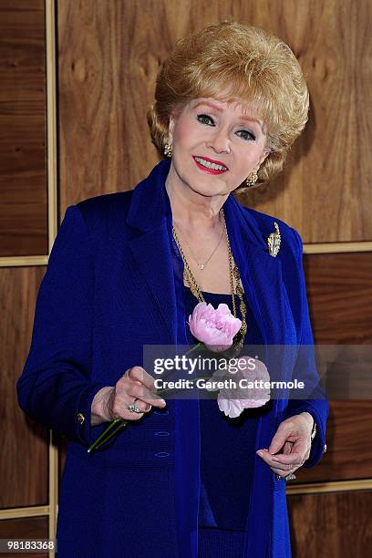Debbie Reynolds poses during a photocall to promote her UK tour 'Alive and Fabulous' on her 78th birthday at The Sofitel Hotel, St James on April 1,...