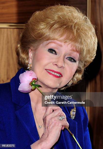 Debbie Reynolds poses during a photocall to promote her UK tour 'Alive and Fabulous' on her 78th birthday at The Sofitel Hotel, St James on April 1,...