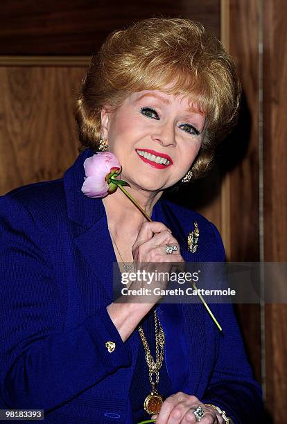 Debbie Reynolds poses during a photocall to promote her UK tour 'Alive and Fabulous' on her 78th birthday at The Sofitel Hotel, St James on April 1,...