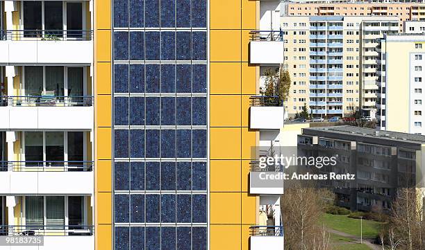 Photovoltaic cells cover the 426 square metre on the 70 m high southern facade of an apartment house stands near concrete 'plattenbau' buildings on...