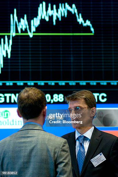 Krzysztof Stupnicki, president of the board at Amplico TFI S.A., right, speaks to a colleague at the Warsaw stock exchange in Warsaw, Poland, on...