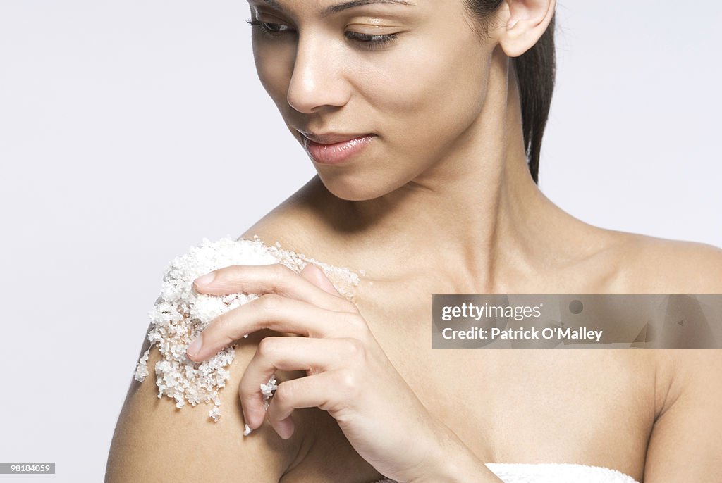 Woman applying bath salts