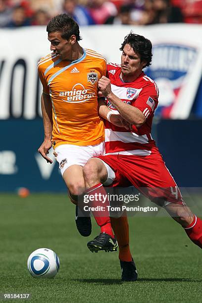 Midfielder Geoff Cameron of the Houston Dynamo controls the ball against defender Heath Pearce FC Dallas during a MLS game at Pizza Hut Park on March...