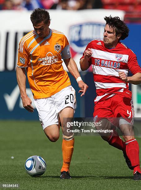 Midfielder Geoff Cameron of the Houston Dynamo controls the ball against defender Heath Pearce FC Dallas during a MLS game at Pizza Hut Park on March...