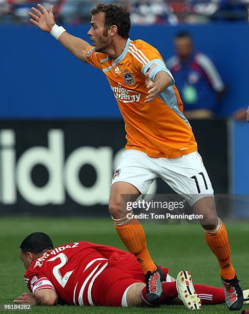 Midfielder Brad Davis of the Houston Dynamo pleads with the referee after colliding with midfielder Daniel Hernandez of FC Dallas during a MLS game...
