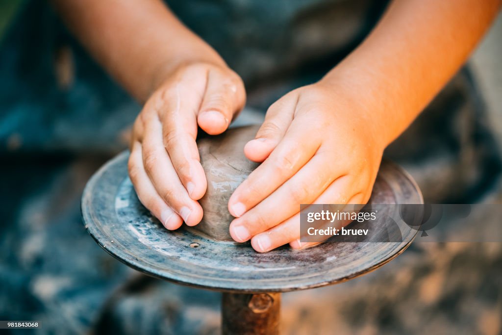 Cropped Hands Of Potter Making Clay Pot At Pottery