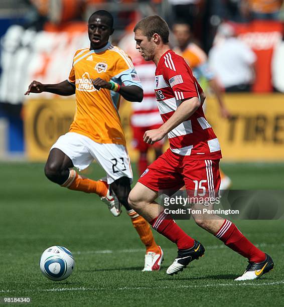 Defender Kyle Davies of FC Dallas moves the ball against forward Dominic Oduro of the Houston Dynamo during a MLS game at Pizza Hut Park on March 27,...