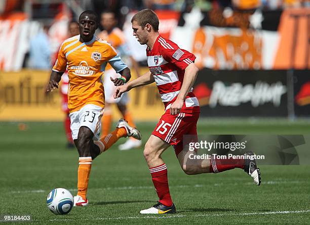 Defender Kyle Davies of FC Dallas moves the ball against forward Dominic Oduro of the Houston Dynamo during a MLS game at Pizza Hut Park on March 27,...