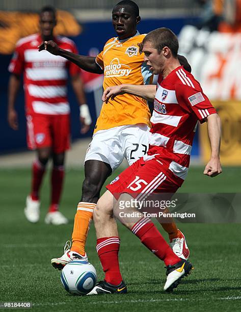 Defender Kyle Davies of FC Dallas moves the ball against forward Dominic Oduro of the Houston Dynamo during a MLS game at Pizza Hut Park on March 27,...