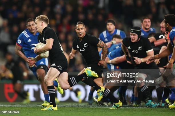 Damian McKenzie of the All Blacks runs away to score a try during the International Test match between the New Zealand All Blacks and France at...