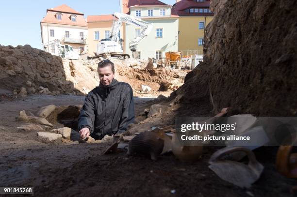 Nicole Eichhorn, lead archaeologist of the State Office, works on a well of the excavation area in the old town where archaeologists discovered...