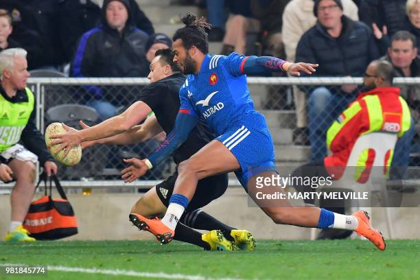 New Zealand's Ben Smith dives on the ball ahead of France's Teddy Thomas during the third and final rugby Test match between the New Zealand All...