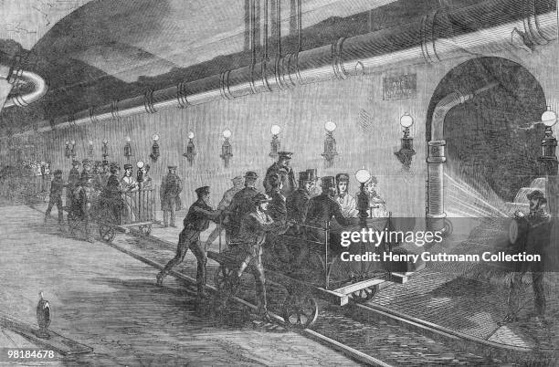 Ladies and gentlemen take a tour of the Parisian sewers, 1870. On the right, a tunnel leads up to Rue Laffitte in the north of the city. Illustration...