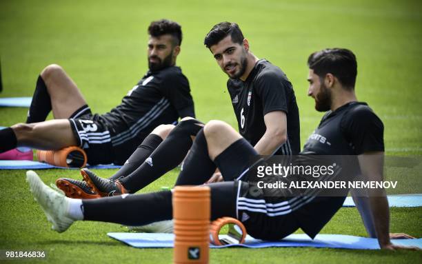 Iran's defender Ramin Rezaian, midfielder Saeid Ezatolahi and forward Alireza Jahanbakhsh execute ground exercice during a training session in...