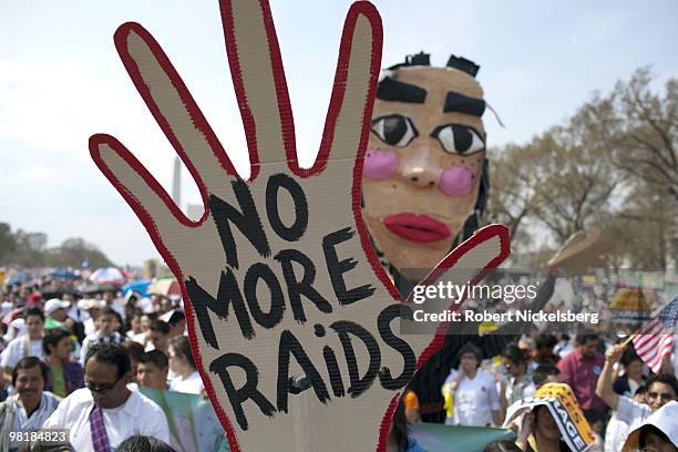 Sign protests government raids on US immigrants near the US Capital Building during a rally for immigration reform March 21, 2010 in Washington, DC....