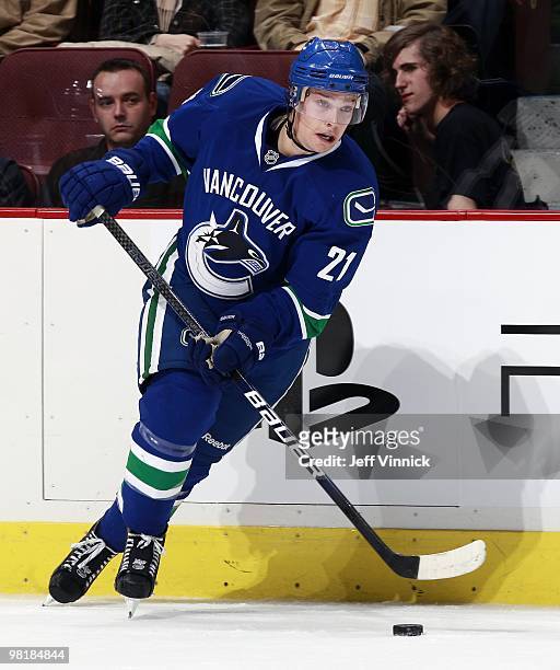 Mason Raymond of the Vancouver Canucks skates up ice with the puck during the game against the New York Islanders at General Motors Place on March...