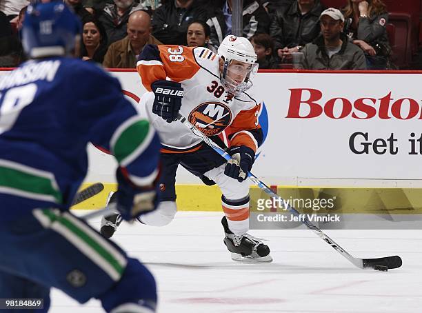 Jack Hillen of the New York Islanders skates up ice with the puck during the game against the Vancouver Canucks at General Motors Place on March 16,...