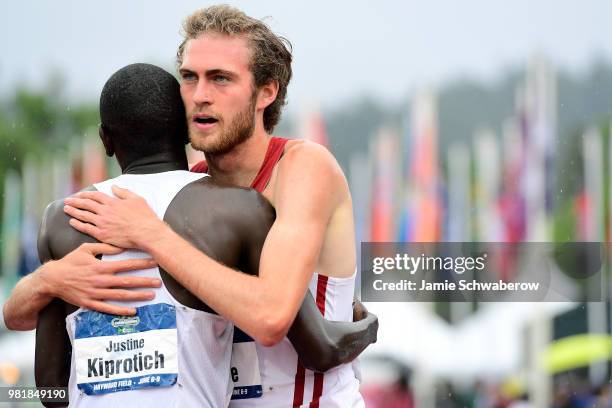 Justine Kiprotich of the Michigan State Spartans congratulates Oliver Hoare of the Wisconsin Badgers after his victory in the 1500 meter run during...